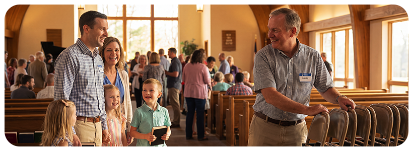 A family waiting for the Usher to get more chairs inside a church